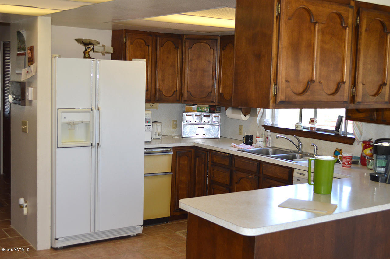 931 Barker Road Granger, WA 98932 - Photo 3 of 22 a kitchen with stainless steel appliances granite countertop a refrigerator a sink and dishwasher