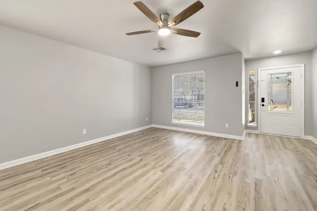 wooden floor in an empty room with a window