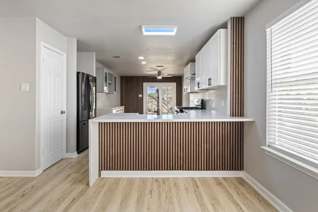 a view of hallway with wooden floor