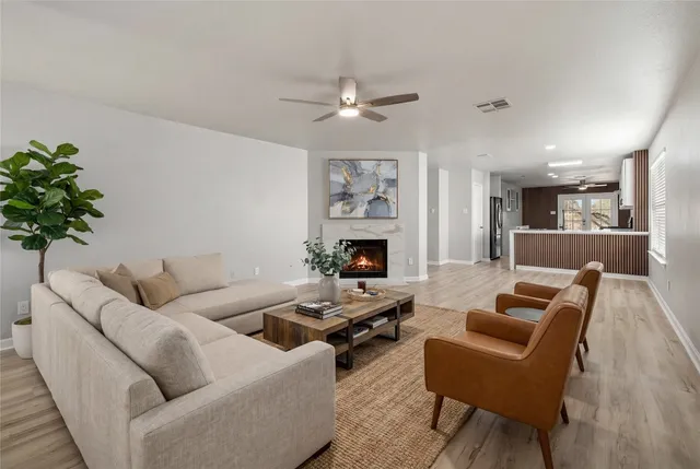 a living room with furniture a fireplace and a potted plant