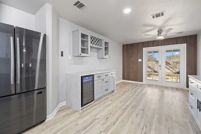 a kitchen with stainless steel appliances a refrigerator and a stove top oven