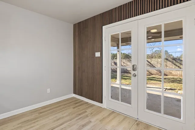 an empty room with wooden floor and a window
