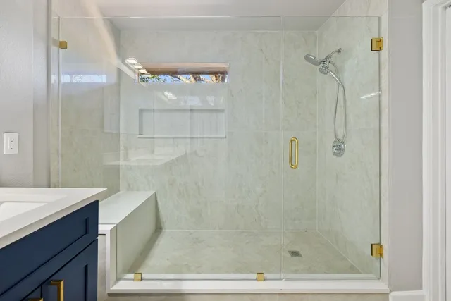 a bathroom with a shower and a sink