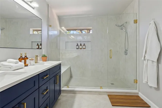 a bathroom with a sink a shower and a mirror