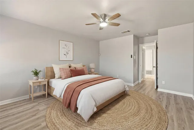 a bedroom with a large bed and a chandelier