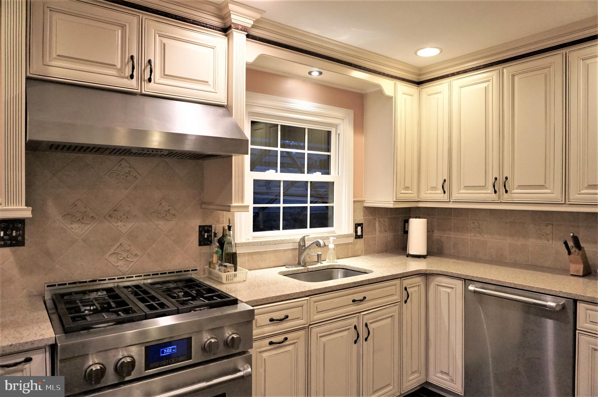 74 Marion Road East Princeton, NJ 08540 - Photo 12 of 32 a kitchen with granite countertop a sink stove and cabinets