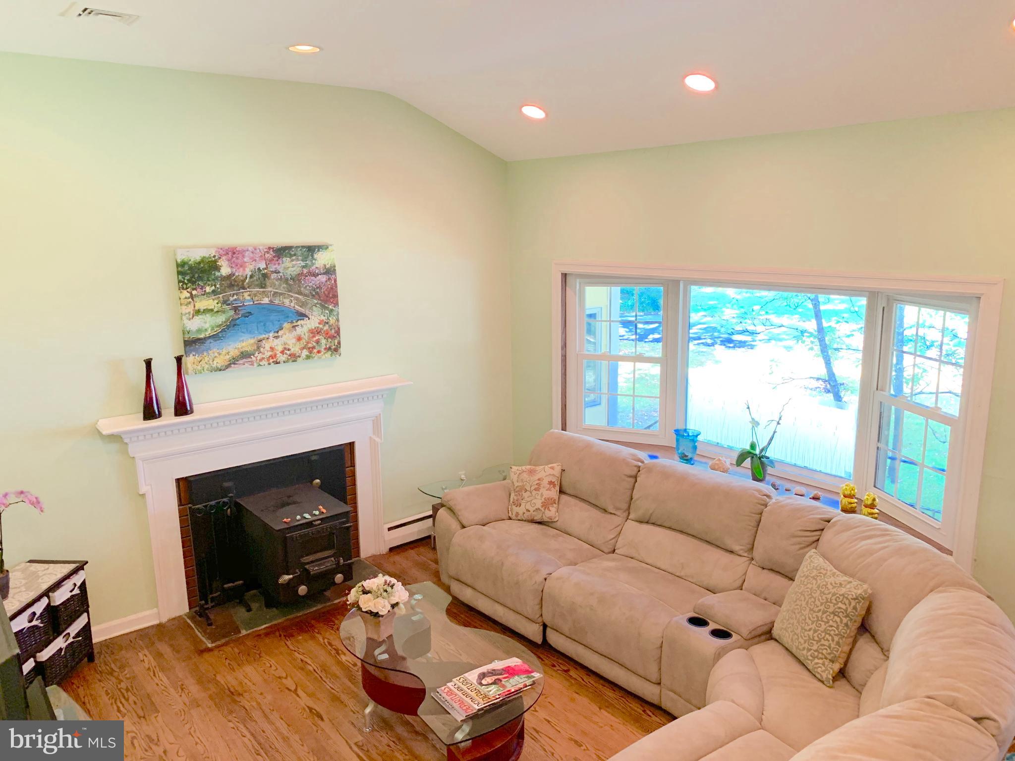 74 Marion Road East Princeton, NJ 08540 - Photo 8 of 32 a living room with furniture a fireplace and a large window