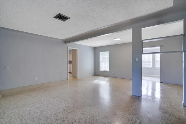 an empty room with windows and entrance