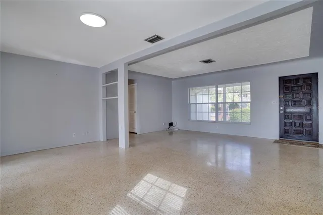 a kitchen with cabinets appliances a sink and a window