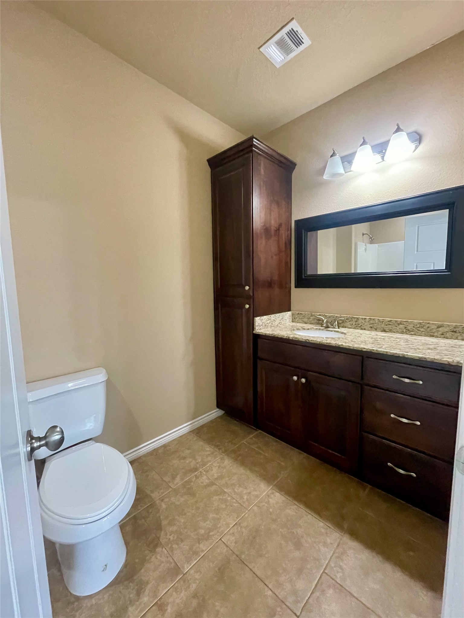 3519 Haverford Road College Station, TX 77845 - Photo 7 of 15 a bathroom with a granite countertop sink a toilet and mirror