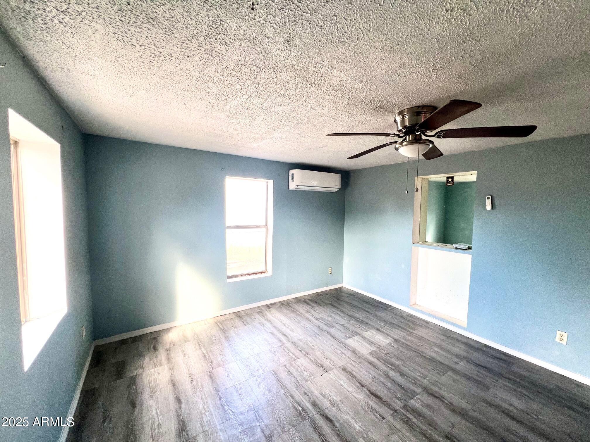 2002 West Lawrence Road Phoenix, AZ 85015 - Photo 15 of 22 a view of empty room with wooden floor and fan