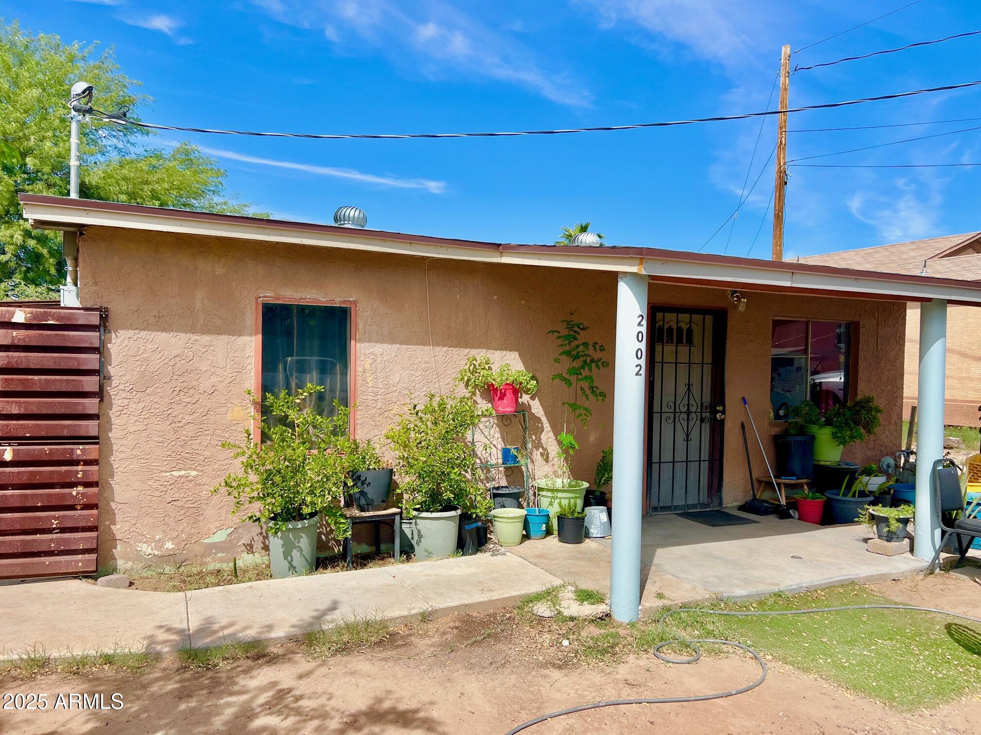 2002 West Lawrence Road Phoenix, AZ 85015 - Photo 2 of 22 a front view of a house with garden