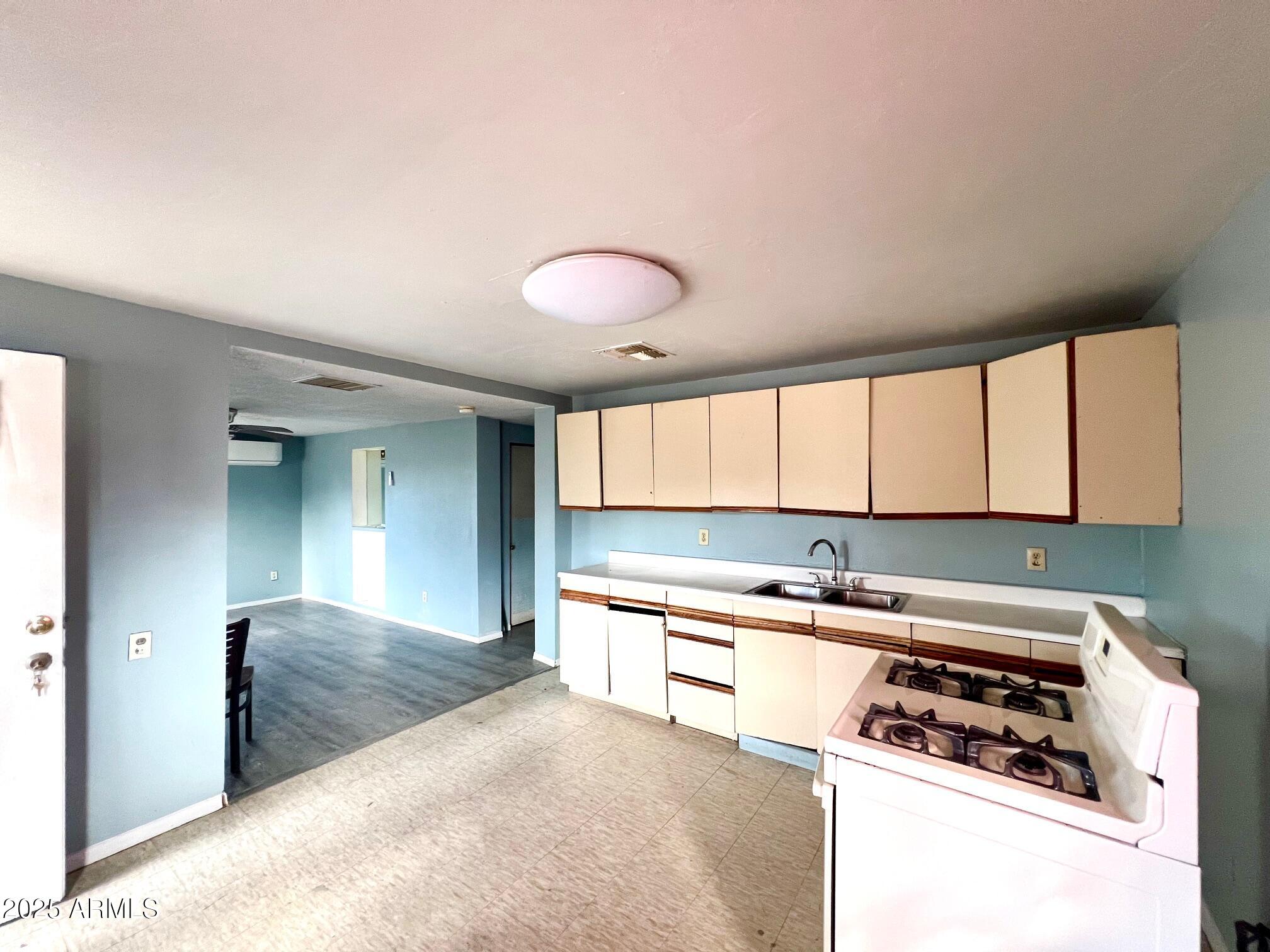 2002 West Lawrence Road Phoenix, AZ 85015 - Photo 21 of 22 a kitchen with stainless steel appliances granite countertop a stove a sink and a refrigerator