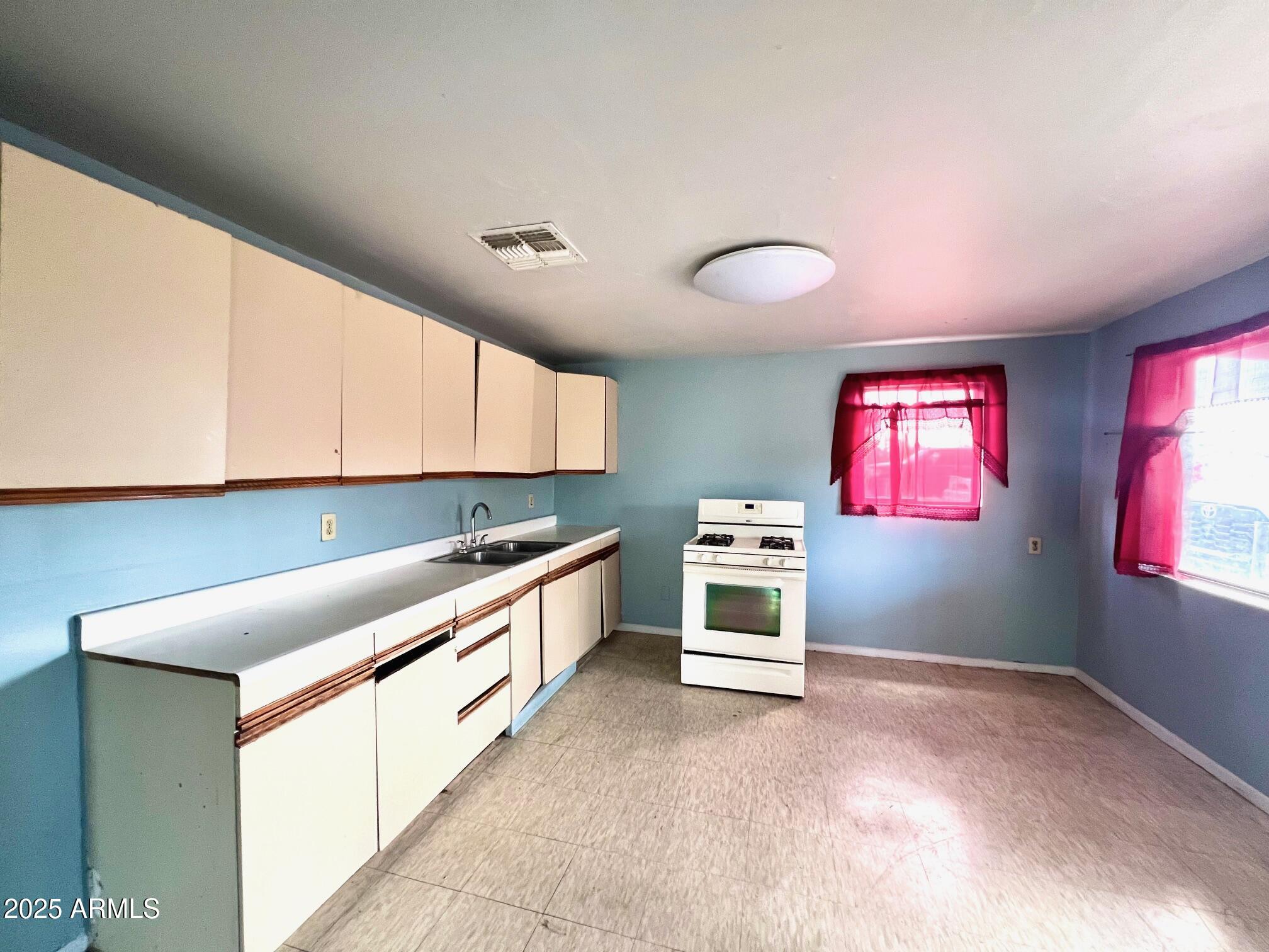 2002 West Lawrence Road Phoenix, AZ 85015 - Photo 22 of 22 a kitchen with granite countertop a stove and a sink