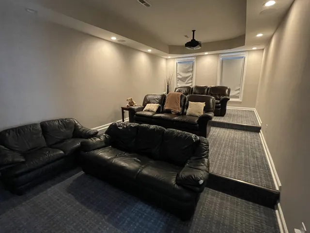 a media room with lots of chairs and a projector screen