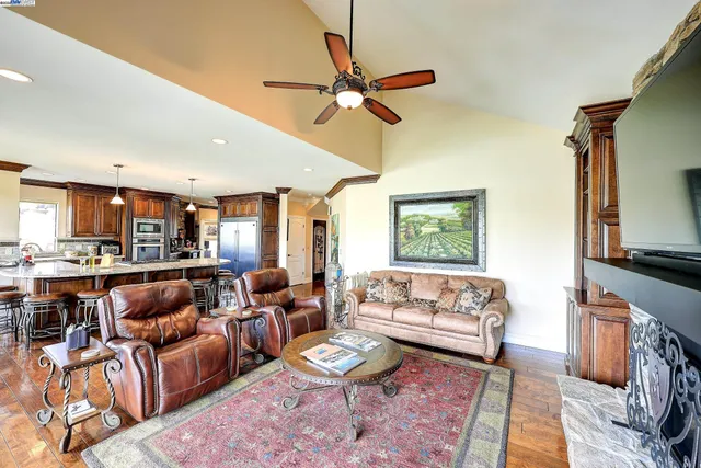 a kitchen with stainless steel appliances kitchen island granite countertop a stove and cabinets