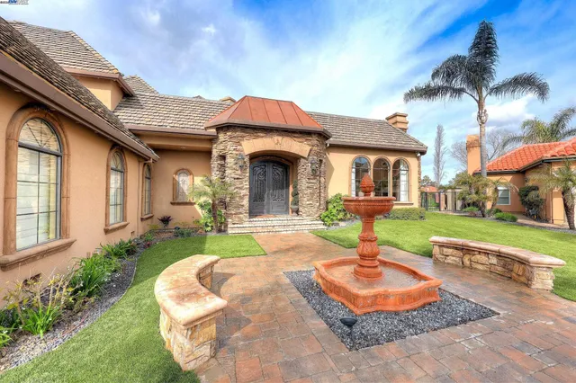 a view of a hallway with wooden floor and workspace