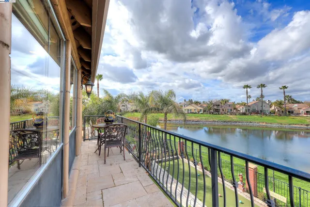 a view of a house with swimming pool and sitting area