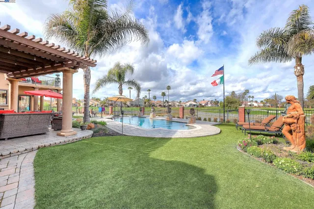 a view of a patio with couches chairs and a fire pit