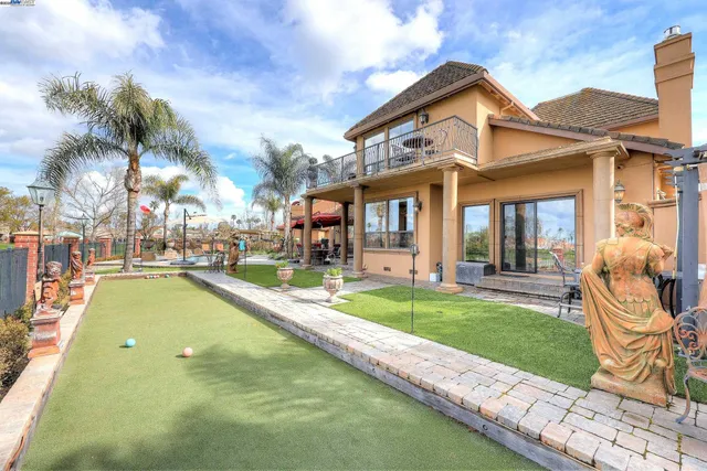 a view of a dining room with furniture a chandelier and wooden floor