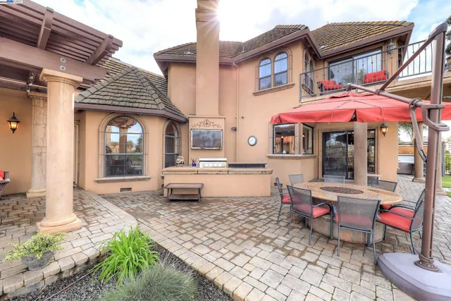 front view of house with a yard and potted plants