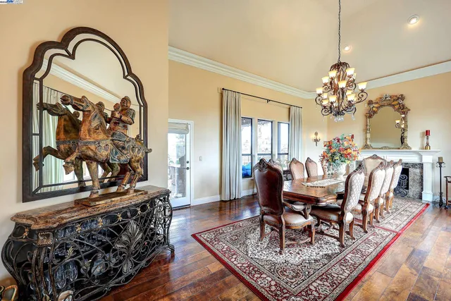 a dining room with furniture a chandelier and a rug