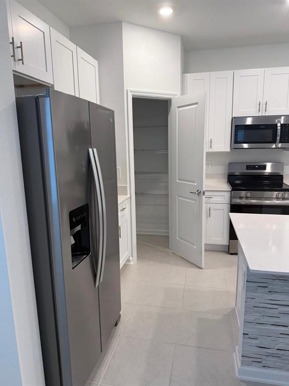 1770 Rider Rain Lane Apopka, FL 32703 - Photo 18 of 86 a kitchen with stainless steel appliances granite countertop a refrigerator and a stove