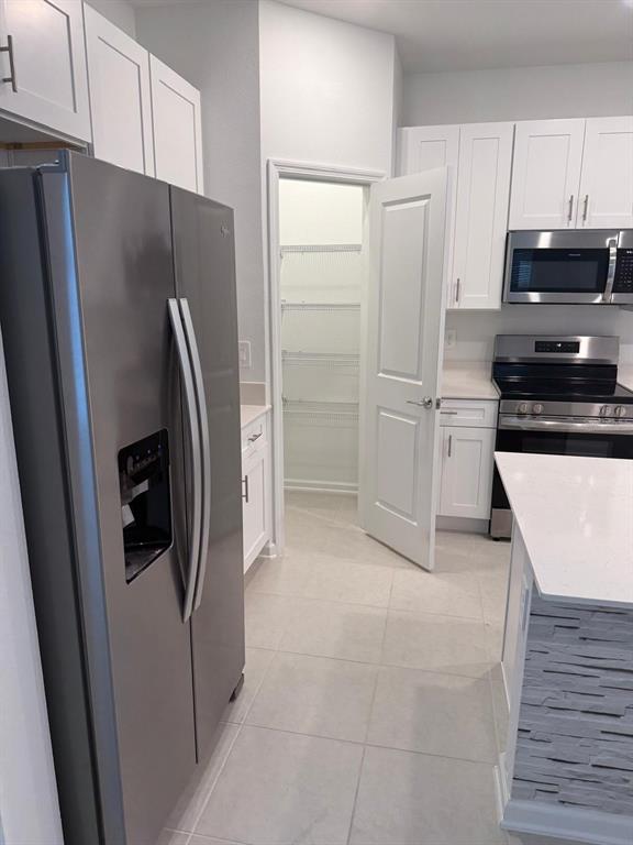 1770 Rider Rain Lane Apopka, FL 32703 - Photo 20 of 86 a kitchen with stainless steel appliances a refrigerator a stove and cabinets