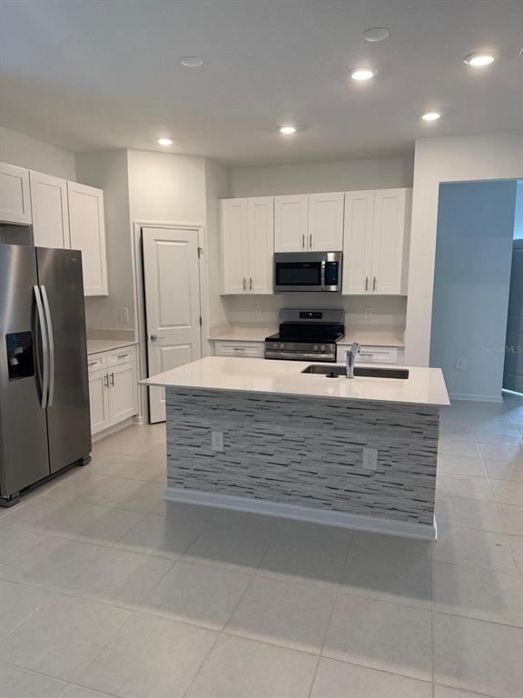 1770 Rider Rain Lane Apopka, FL 32703 - Photo 27 of 86 a view of kitchen center refrigerator and microwave