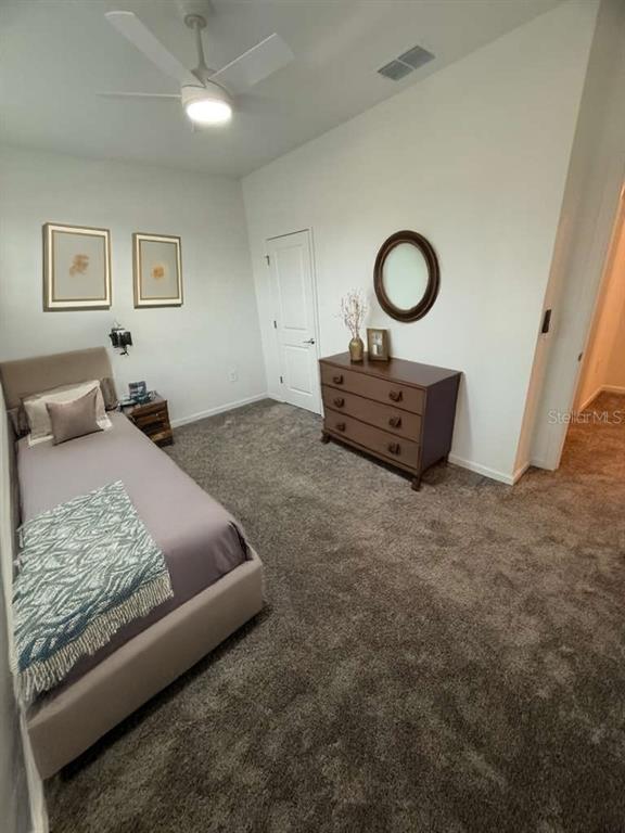 1770 Rider Rain Lane Apopka, FL 32703 - Photo 29 of 86 a bedroom with a bed and a couch