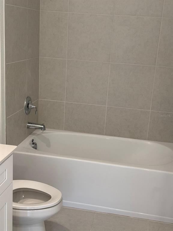1770 Rider Rain Lane Apopka, FL 32703 - Photo 33 of 86 a white bath tub sitting next to a white toilet