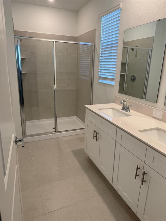 1770 Rider Rain Lane Apopka, FL 32703 - Photo 44 of 86 a spacious bathroom with a granite countertop sink a mirror and shower