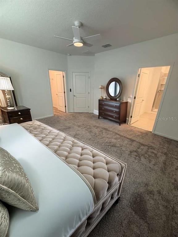 1770 Rider Rain Lane Apopka, FL 32703 - Photo 49 of 86 a spacious bedroom with a bed and a couch