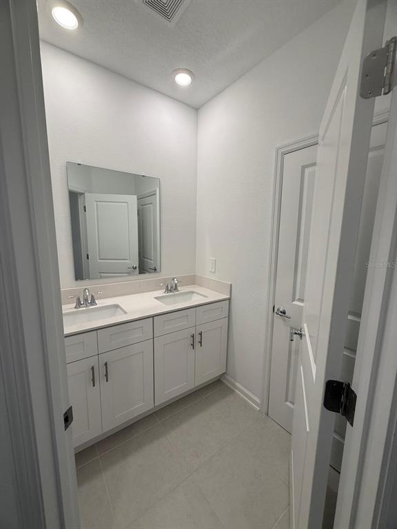 1770 Rider Rain Lane Apopka, FL 32703 - Photo 55 of 86 a spacious bathroom with a double vanity sink and a mirror