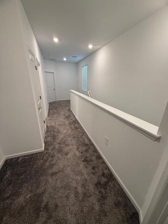 1770 Rider Rain Lane Apopka, FL 32703 - Photo 72 of 86 a view of a hallway with stairs