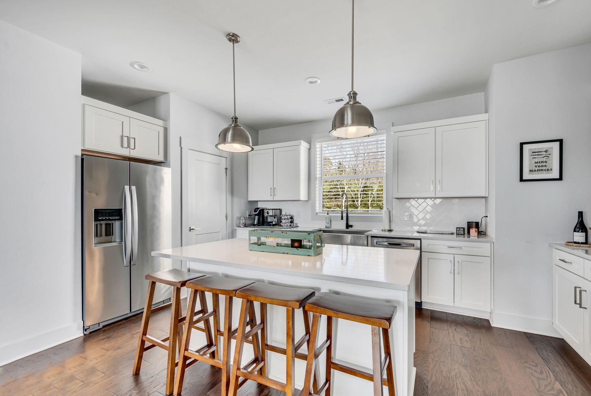 740 Inspiration Boulevard Madison, TN 37115 - Photo 17 of 55 a kitchen with stainless steel appliances granite countertop a stove a sink dishwasher a refrigerator white cabinets and wooden floor