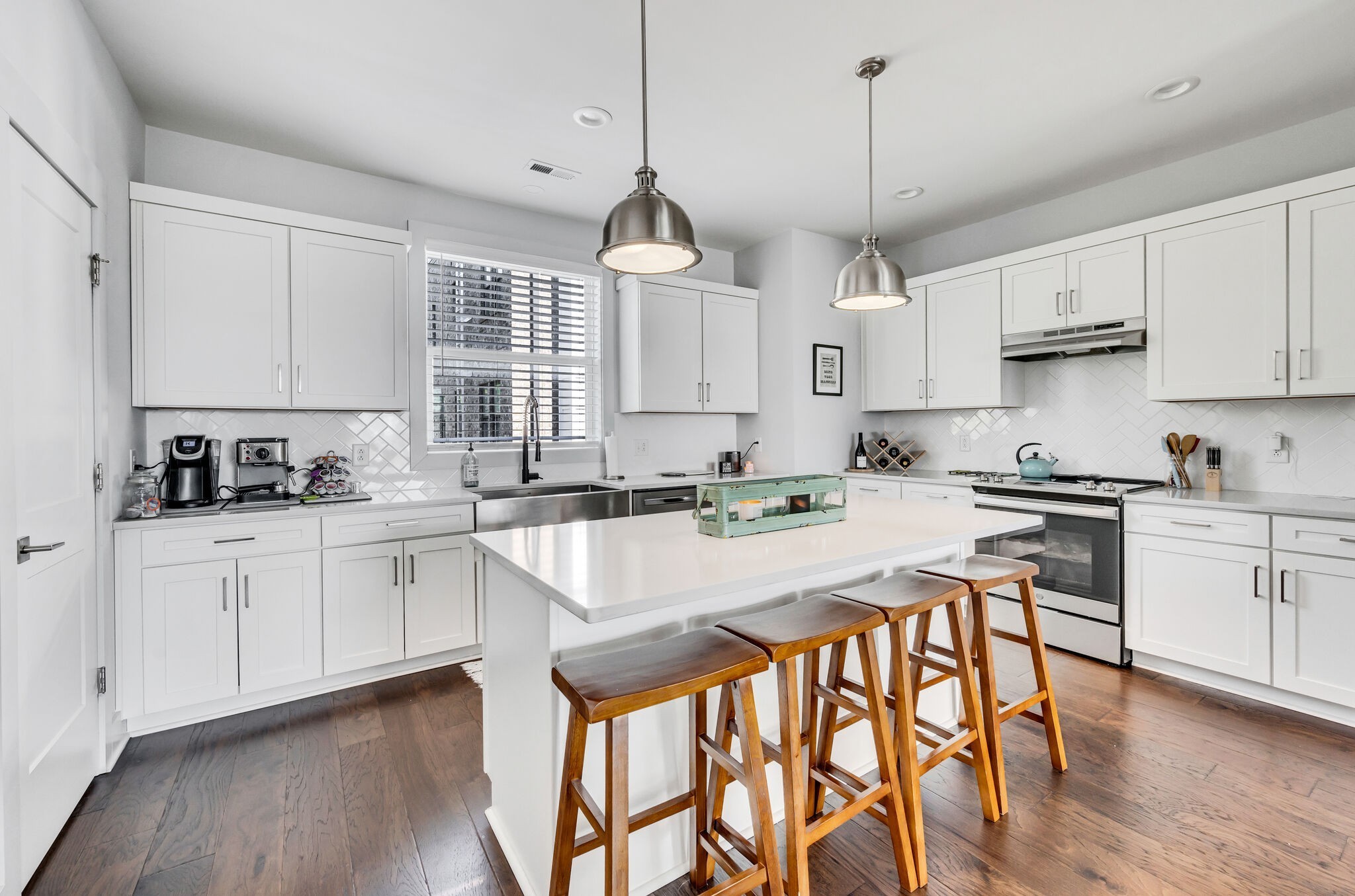 740 Inspiration Boulevard Madison, TN 37115 - Photo 18 of 55 a kitchen with stainless steel appliances granite countertop a stove a sink dishwasher a stove a refrigerator and white cabinets with wooden floor