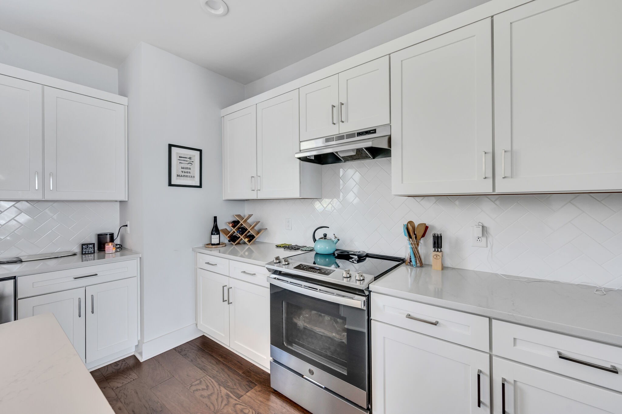 740 Inspiration Boulevard Madison, TN 37115 - Photo 19 of 55 a kitchen with white cabinets and white appliances