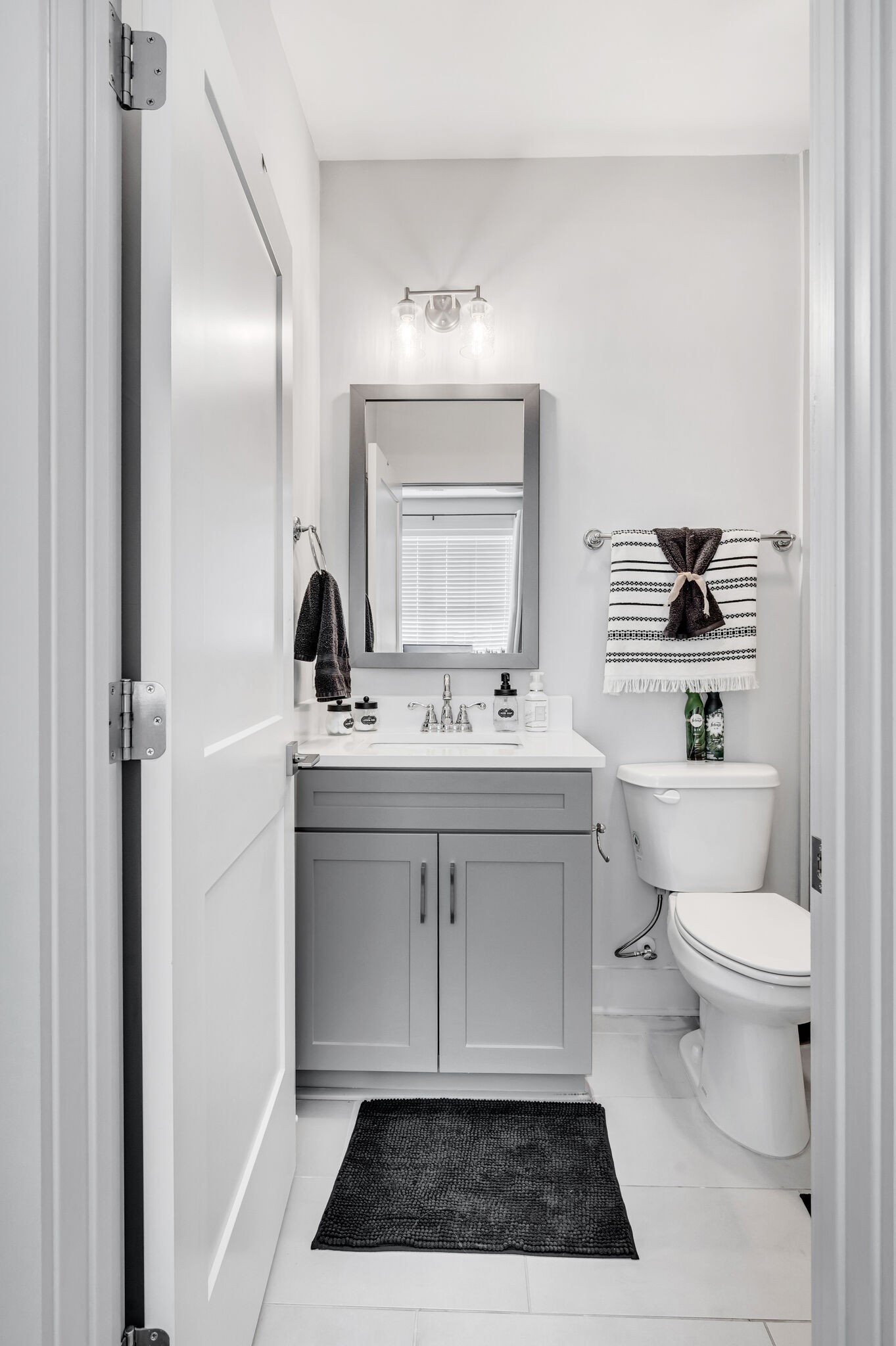 740 Inspiration Boulevard Madison, TN 37115 - Photo 31 of 55 a bathroom with a sink toilet a mirror and vanity