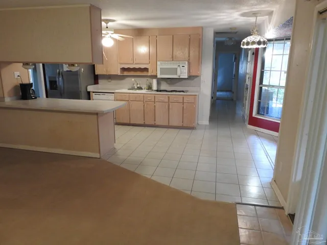 a large kitchen with cabinets and stainless steel appliances