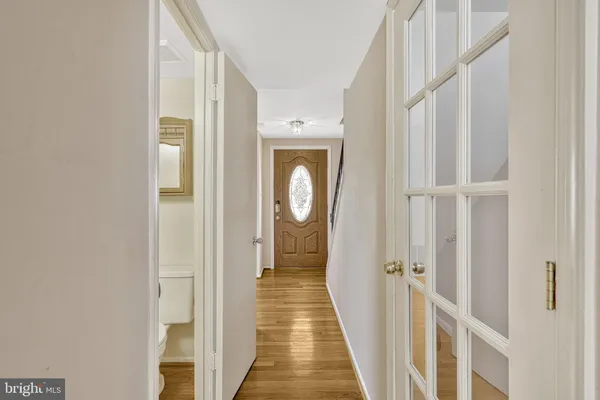 a view of a hallway with wooden floor and entryway