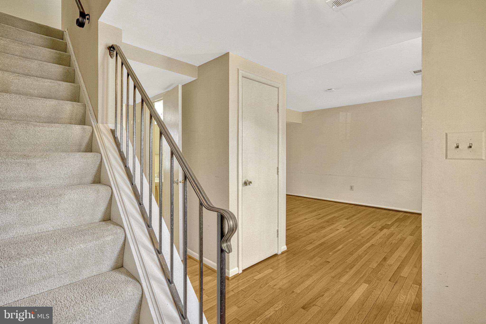 5540 Kendrick Lane Burke, VA 22015 - Photo 12 of 40 a view of staircase with wooden floor and a rug