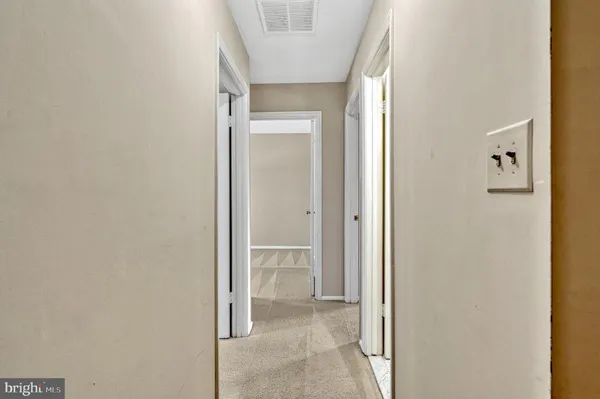 a view of a bathroom from a corridor