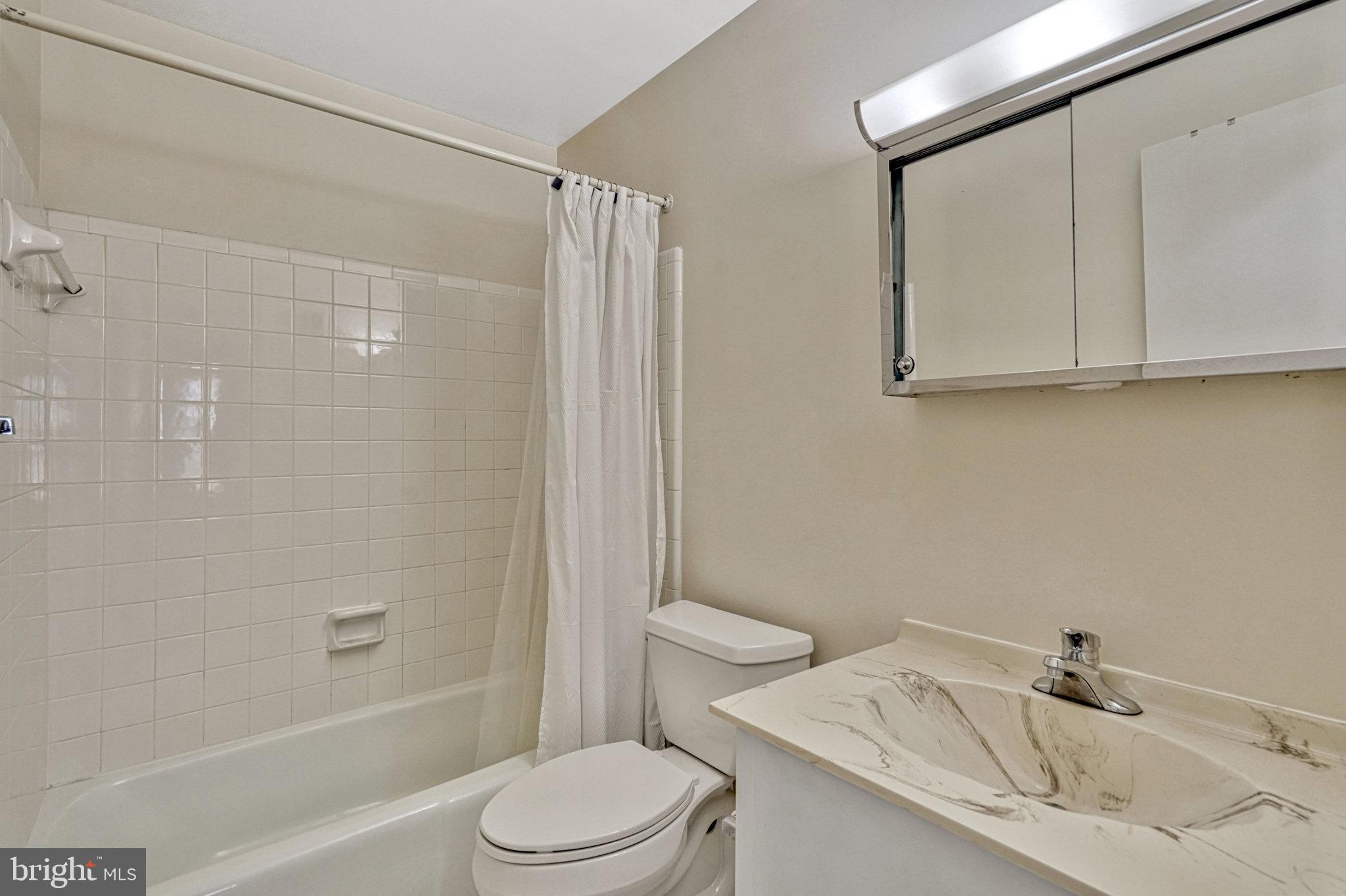 5540 Kendrick Lane Burke, VA 22015 - Photo 14 of 40 a bathroom with a sink a toilet and shower