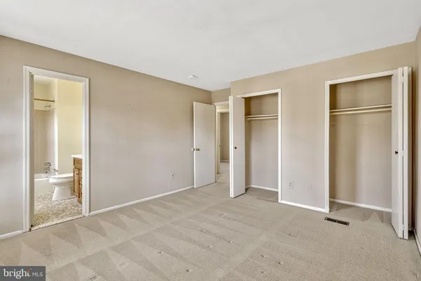 a view of an empty room with glass door and bedroom