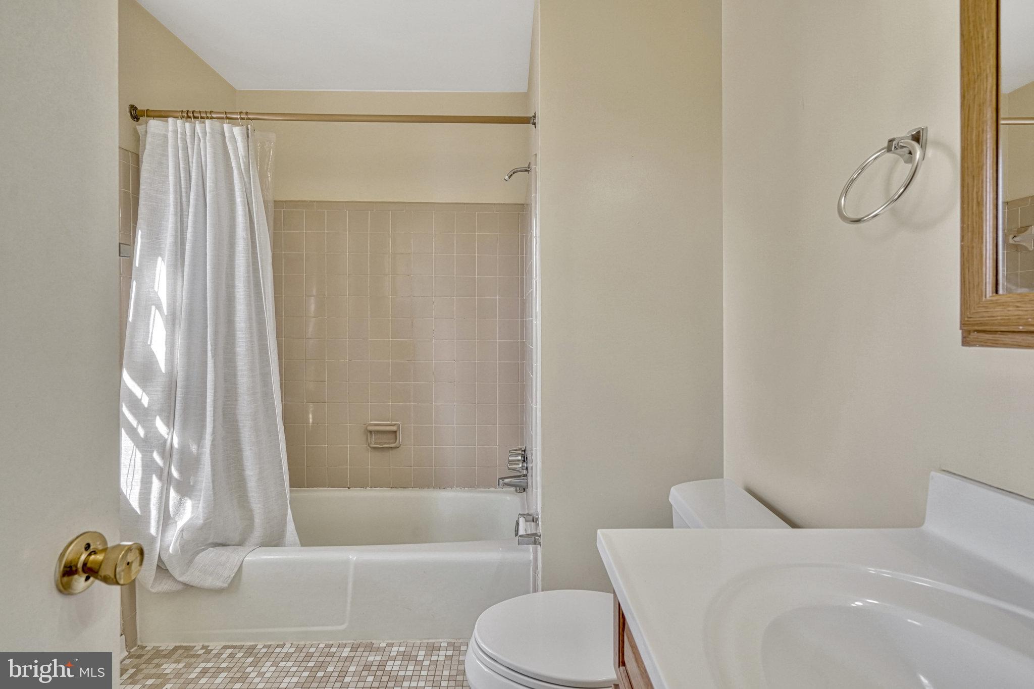 5540 Kendrick Lane Burke, VA 22015 - Photo 24 of 40 a bathroom with a granite countertop bathtub shower and toilet