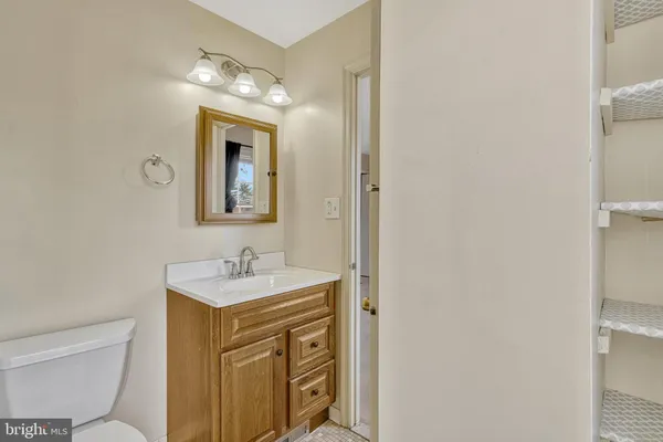 a bathroom with a toilet sink and mirror