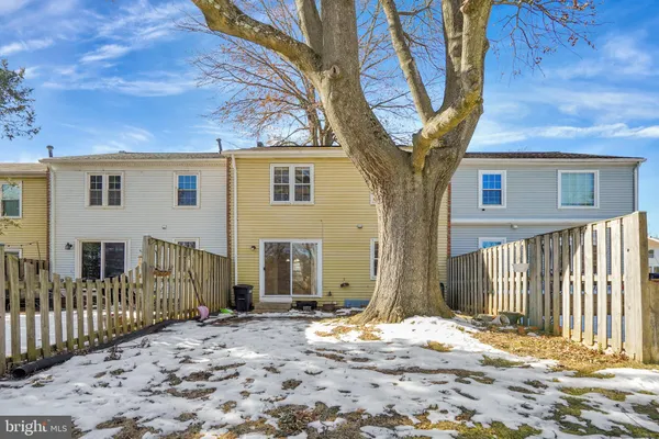 a front view of a house with a tree