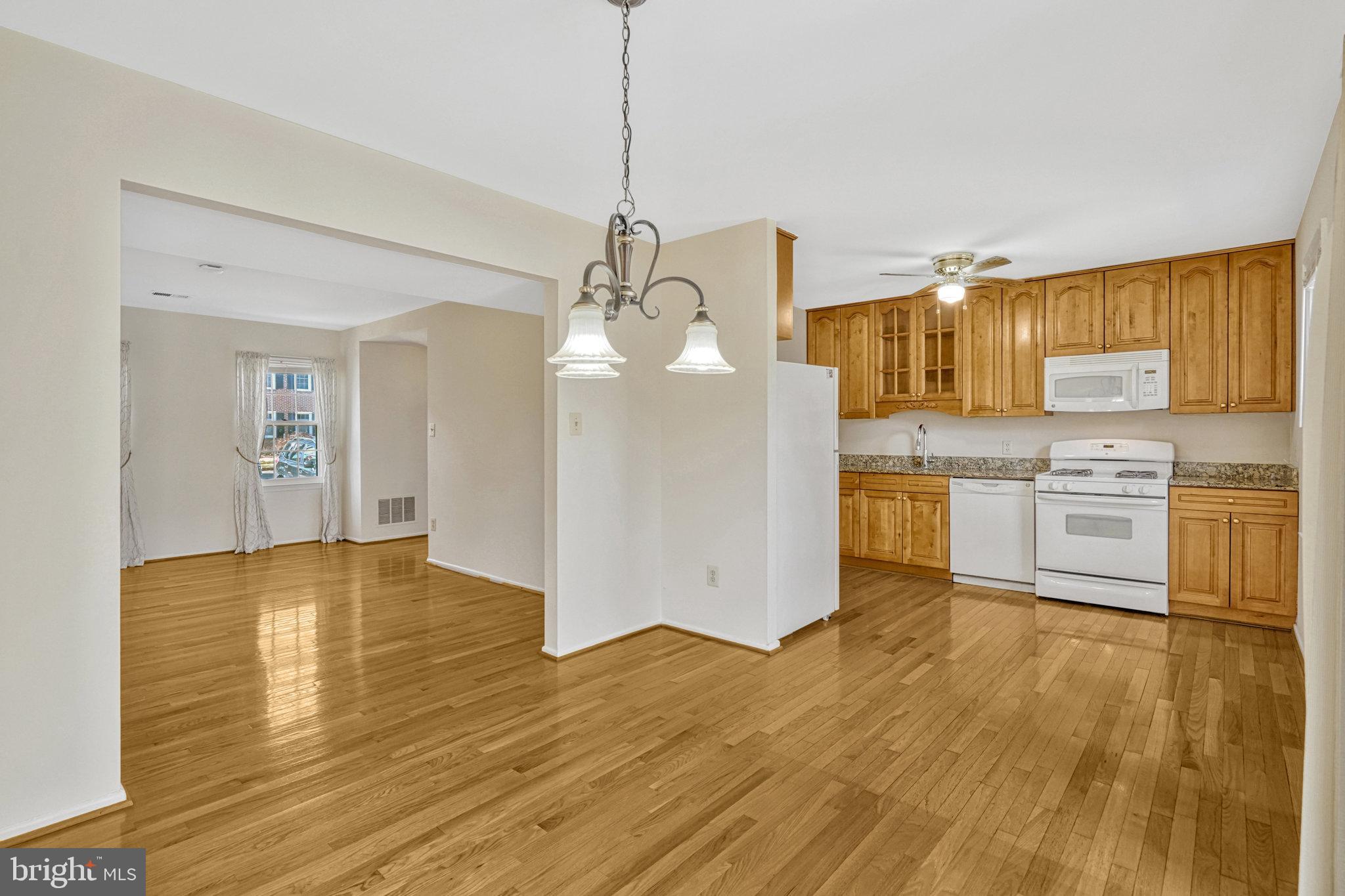 5540 Kendrick Lane Burke, VA 22015 - Photo 6 of 40 a view of a kitchen with a sink wooden floor and a living room
