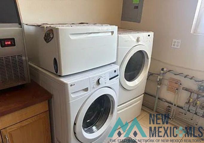 32 Hickey Road Pie Town, NM 87827 - Photo 29 of 39 Laundry room featuring washer / clothes dryer, light tile patterned floors, and electric panel
